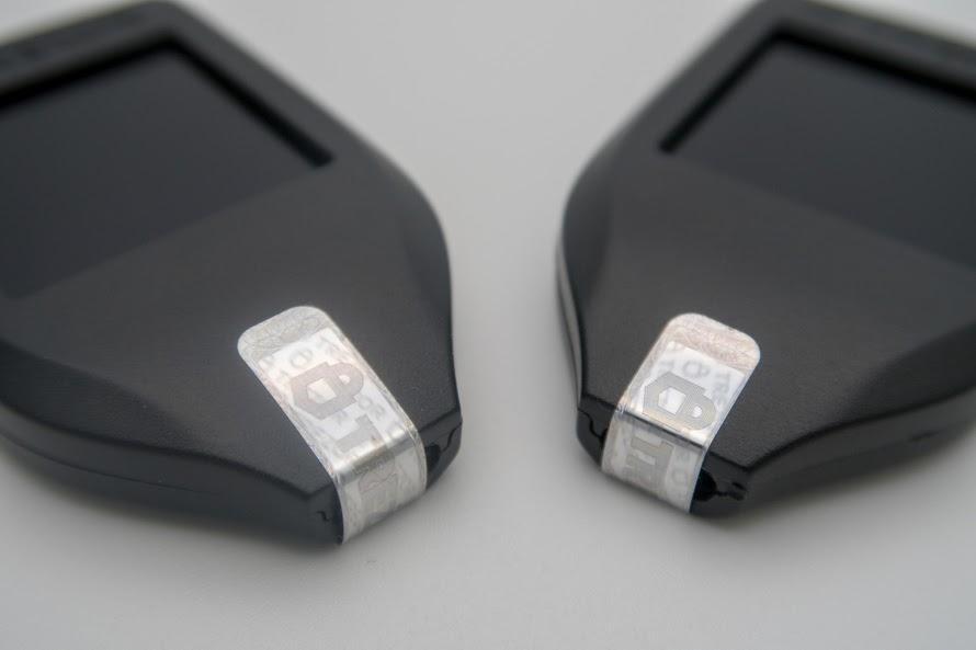 Photo of two Trezor Model T's highlighting the hologram seal still intact. 
