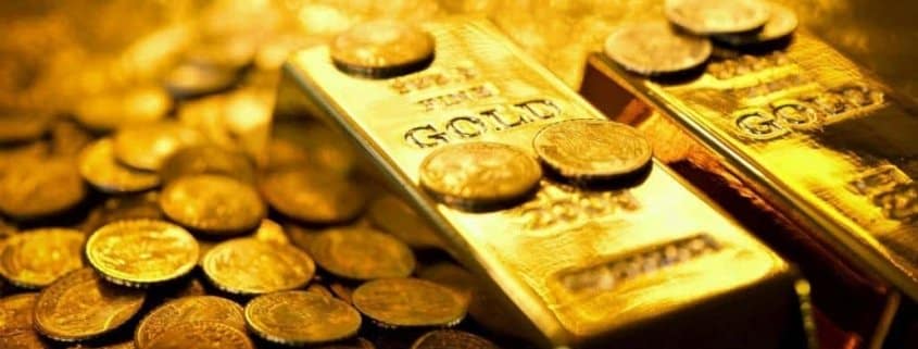 Gold bars next to Physical Bitcoin BTC Coin