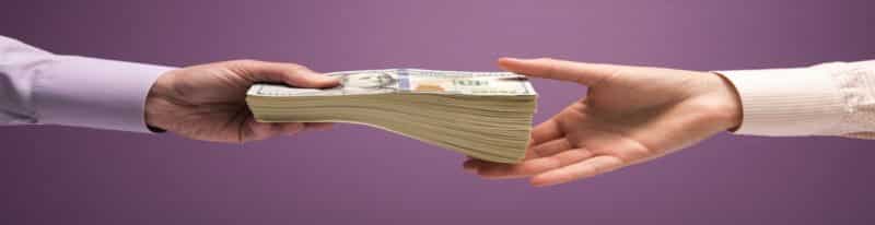 Man handing money NZD to another man in cash