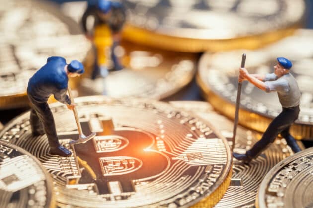 Macro shot of action figures lifting a bitcoin to illustrate the idea that crypto is more than just for investments. Macro shot of action figures lifting a bitcoin to illustrate the idea that crypto is more than just for investments.