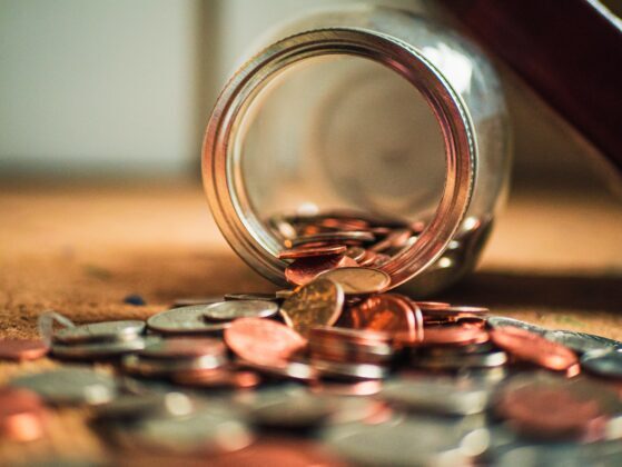 alltokens.coins Tokens spilling out from a jar.