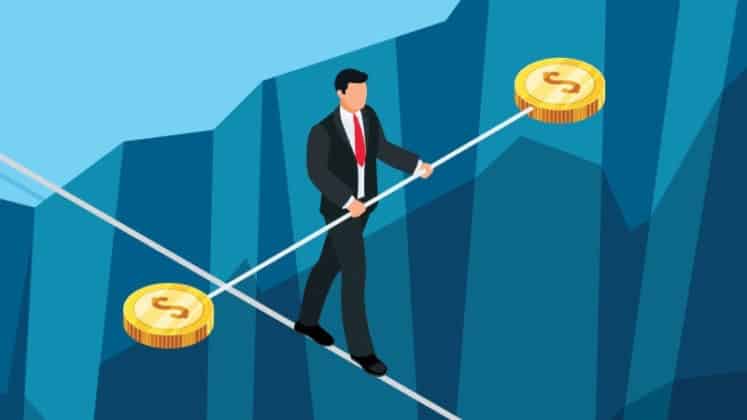 people holding a stick with dollar coins