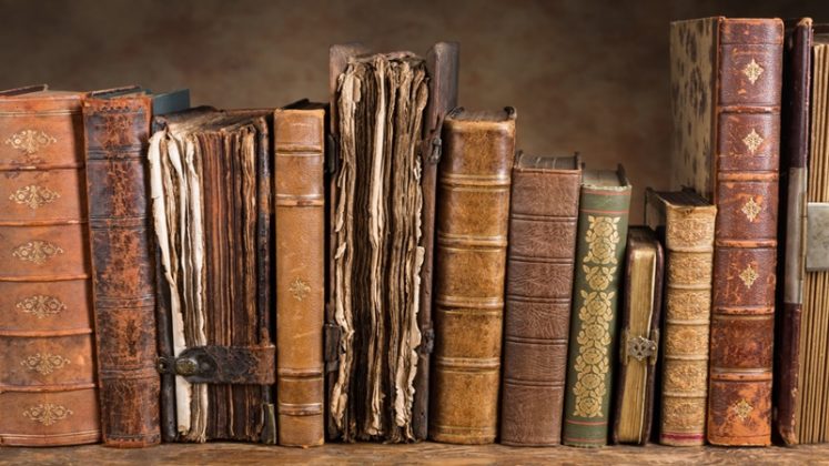 Old leather books on a book case