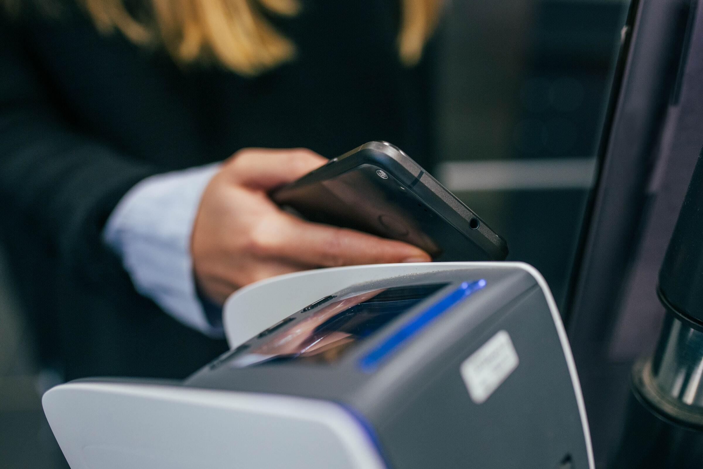 Person paying cashless using a mobile phone.