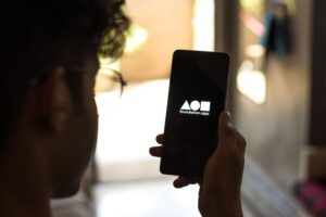 Man looking at phone showing the Foundation app