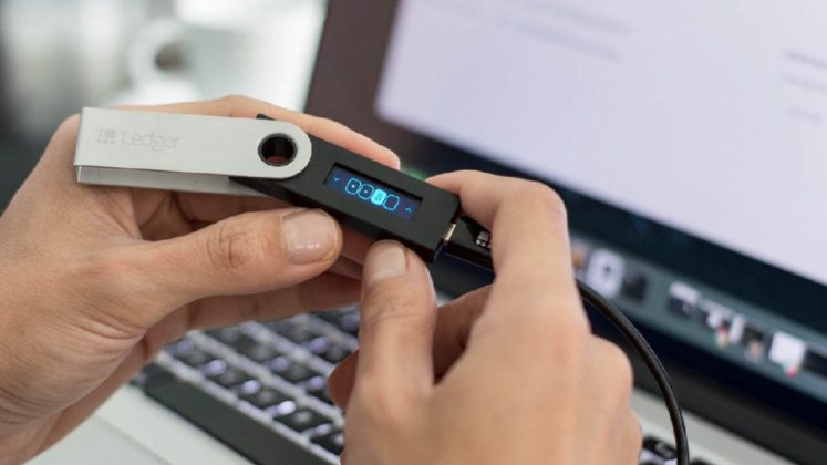 ledger-hardware-bitcoin-cryptocurrency-wallet A person is holding a Ledger cryptocurrency wallet, one of the safest places to store Bitcoin (BTC)