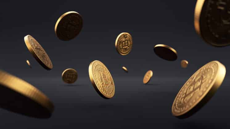 Falling Bitcoins on dark grey background.