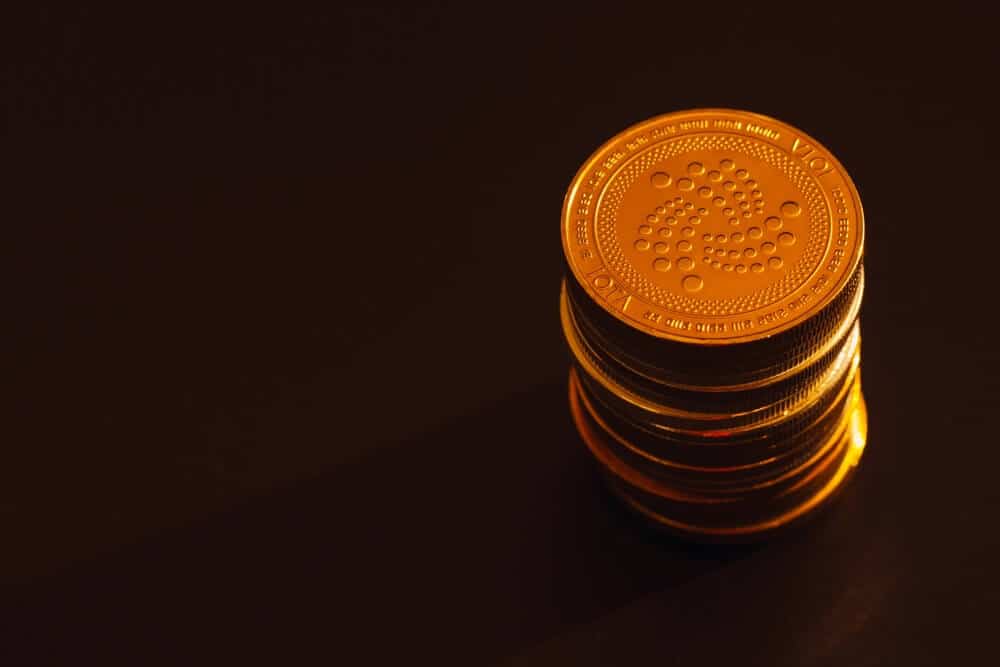 Image showcasing physical IOTA coins on black background