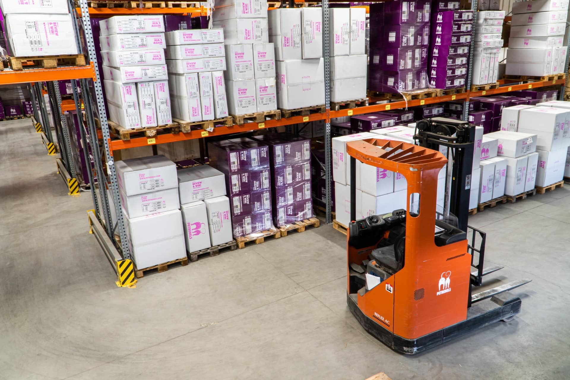 Orange forklift in a warehouse.