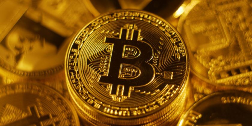 Shiney gold Bitcoin logo on gold coins BTC NZ