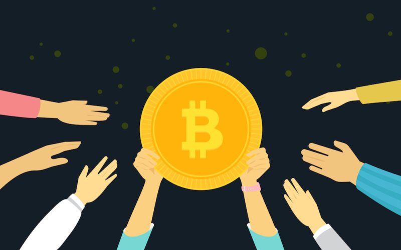 Black Background with a bunch of people holding up a golden bitcoin