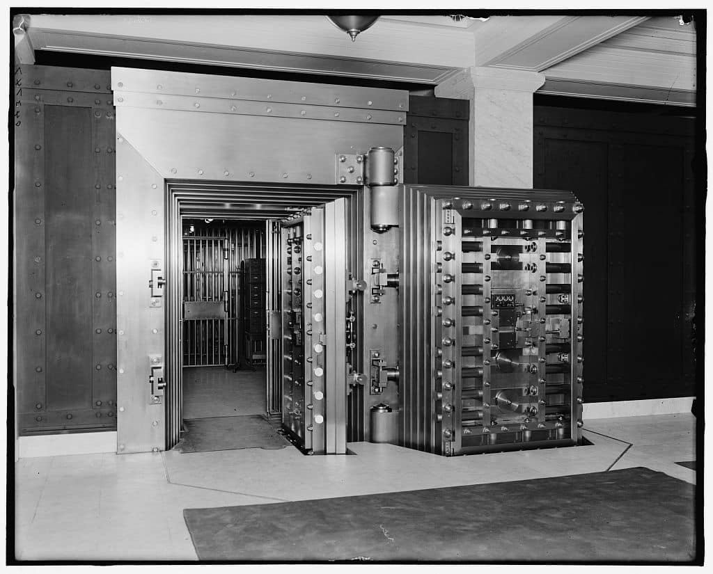 A giant metal safe inside a bank.