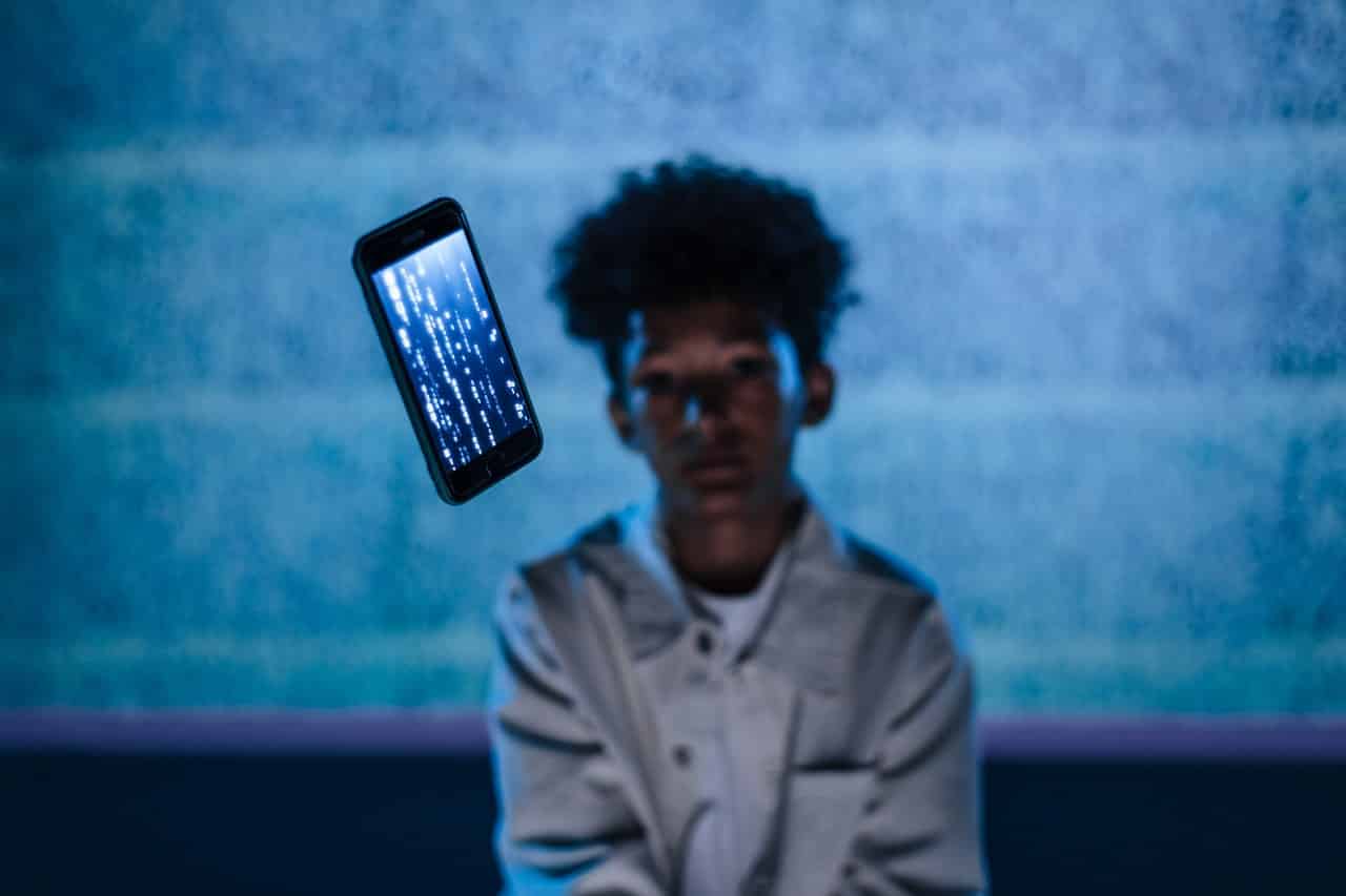 Photo of a smartphone floating in front of a person to illustrate the idea of smart contracts. 