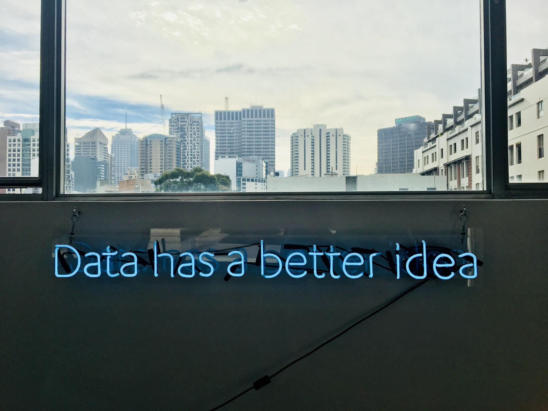 Photo of a window with a neon sign saying Data has a better idea.