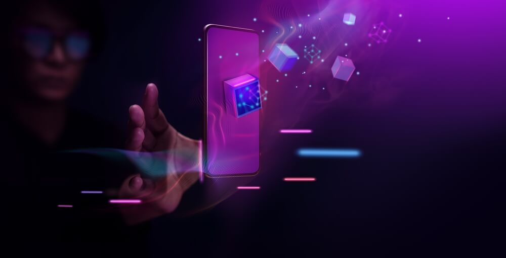 Person holding a phone to resemble whos the creator behind an NFT project