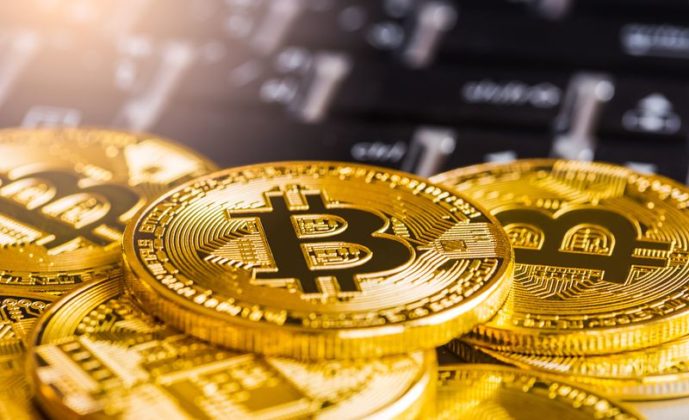 Golden bitcoin BTC on laptop