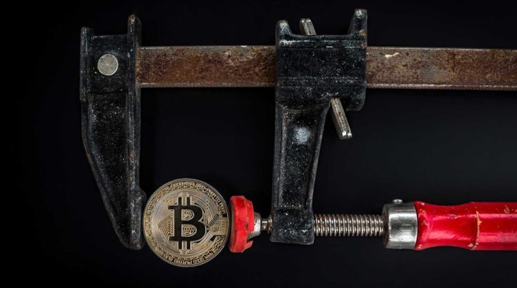 black-and-red-caliper-on-gold-colored-bitcoin-1099339-753x420-1 A Bitcoin is being measured to illustrate cryptocurrency balance