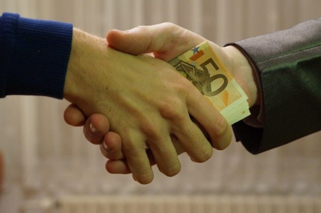 Close up shot of a handshake to illustrate choosing a secure crypto exchange to work with Close up shot of a handshake to illustrate choosing a secure crypto exchange to work with