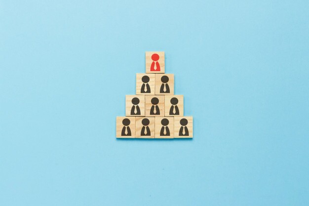 pyramid-wooden-plates-with-icons-people-with-ties-blue-background-concept-corporation-scheme-company-pyramid-corporate-growth-promotion-dismissal-flat-lay-top-view MLM Pyramid Scheme