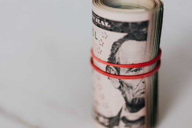Photo of a rolled up US Dollar to illustrate Easy Crypto saving investor from scam.