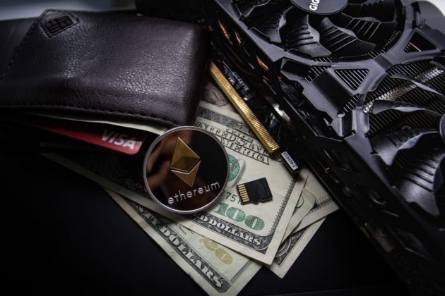 Ethereum coin on top of a desk surrounded USD and wallet Ethereum coin on top of a desk surrounded USD and wallet