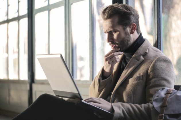 A man is thinking while looking at his Easy Crypto wallet from the computer