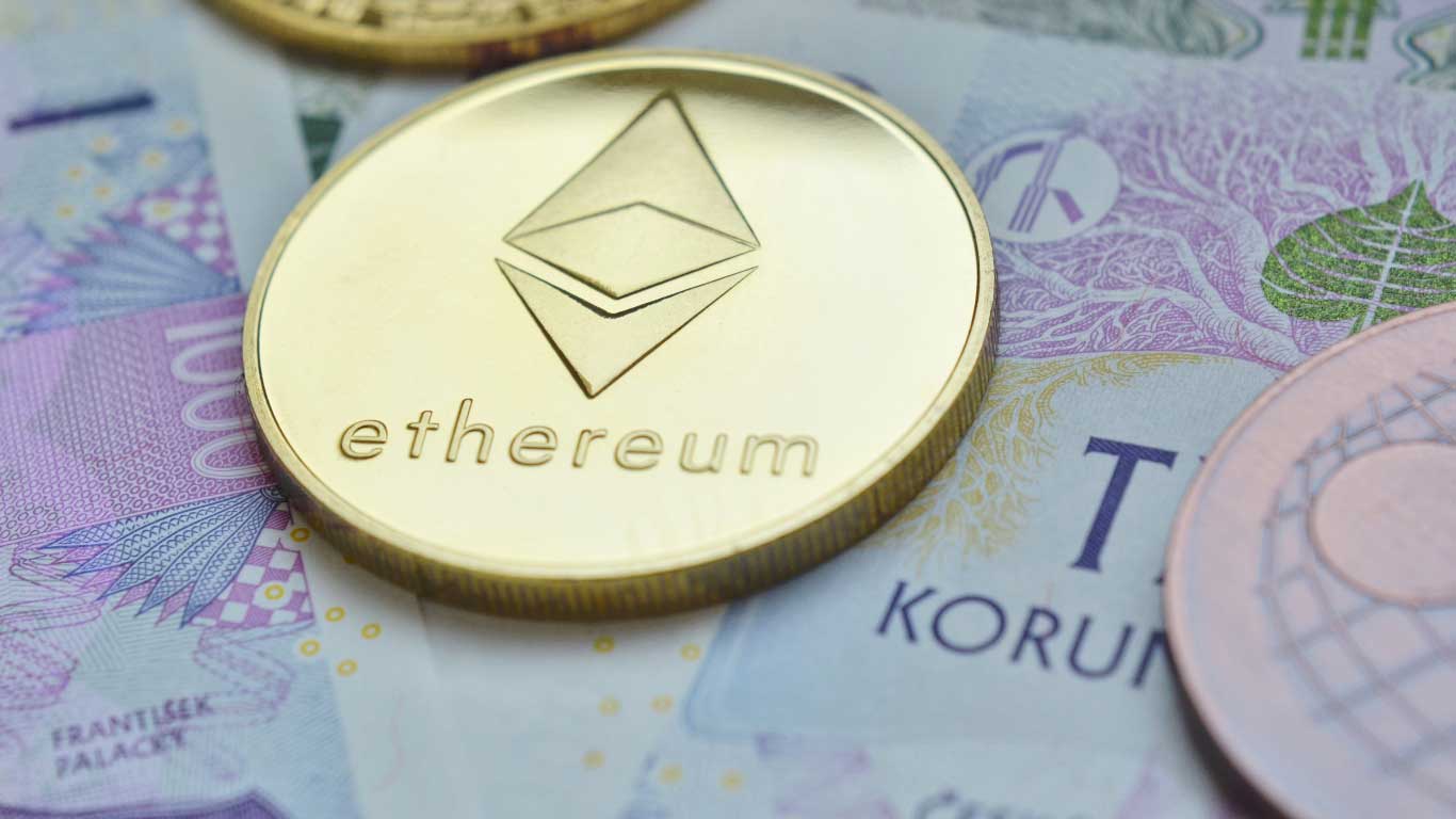 Ethereum (ETH) is illustrated asa gold coin and laying over South Africa rand