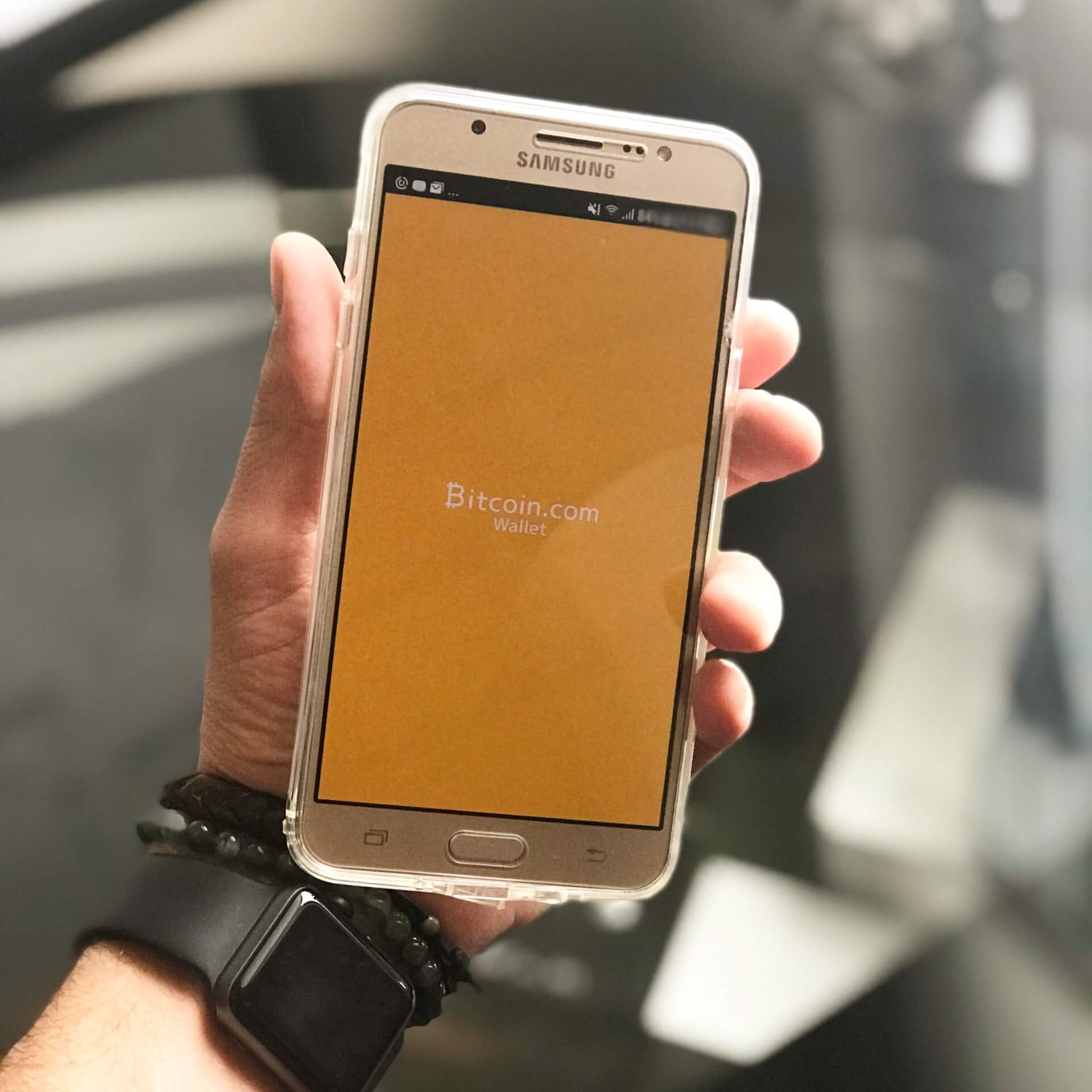 Photo of a mobile device displaying an image of a bitcoin wallet