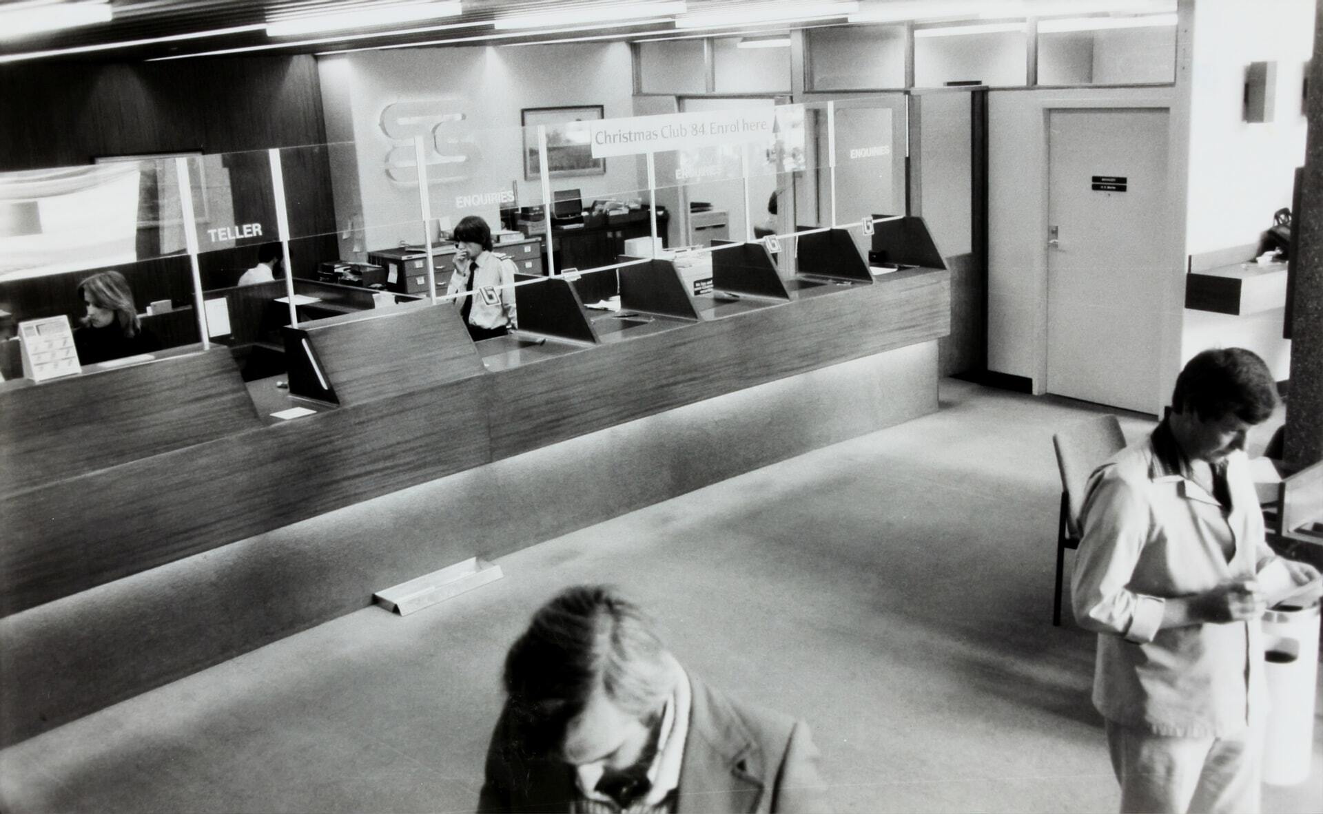 A black and white image of a bank teller to depict the topic of crypto friendly banks.