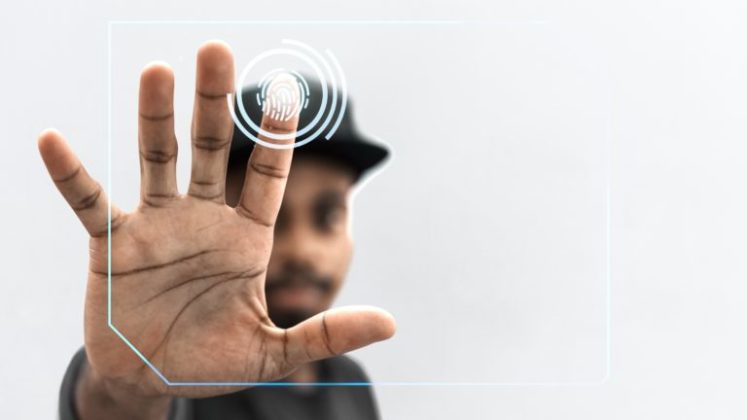 Picture of a man putting fingerprint as his digital identity to illustrate one of NEO's integration with blockchain technology