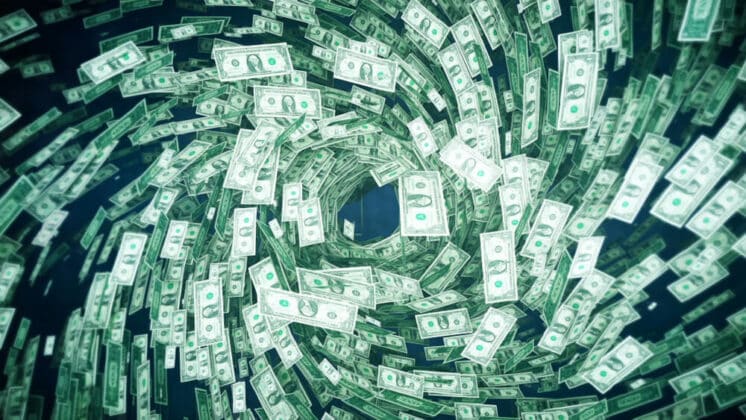 Dollar bills spinning in a tornado