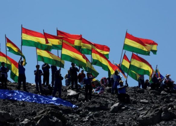 bolivian-flags-hoisted-by-people-on-top-of-a-hill