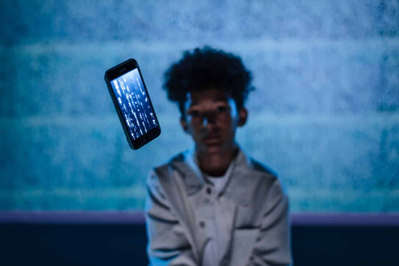 Photo of a smartphone floating in front of a person to illustrate the idea of smart contracts.